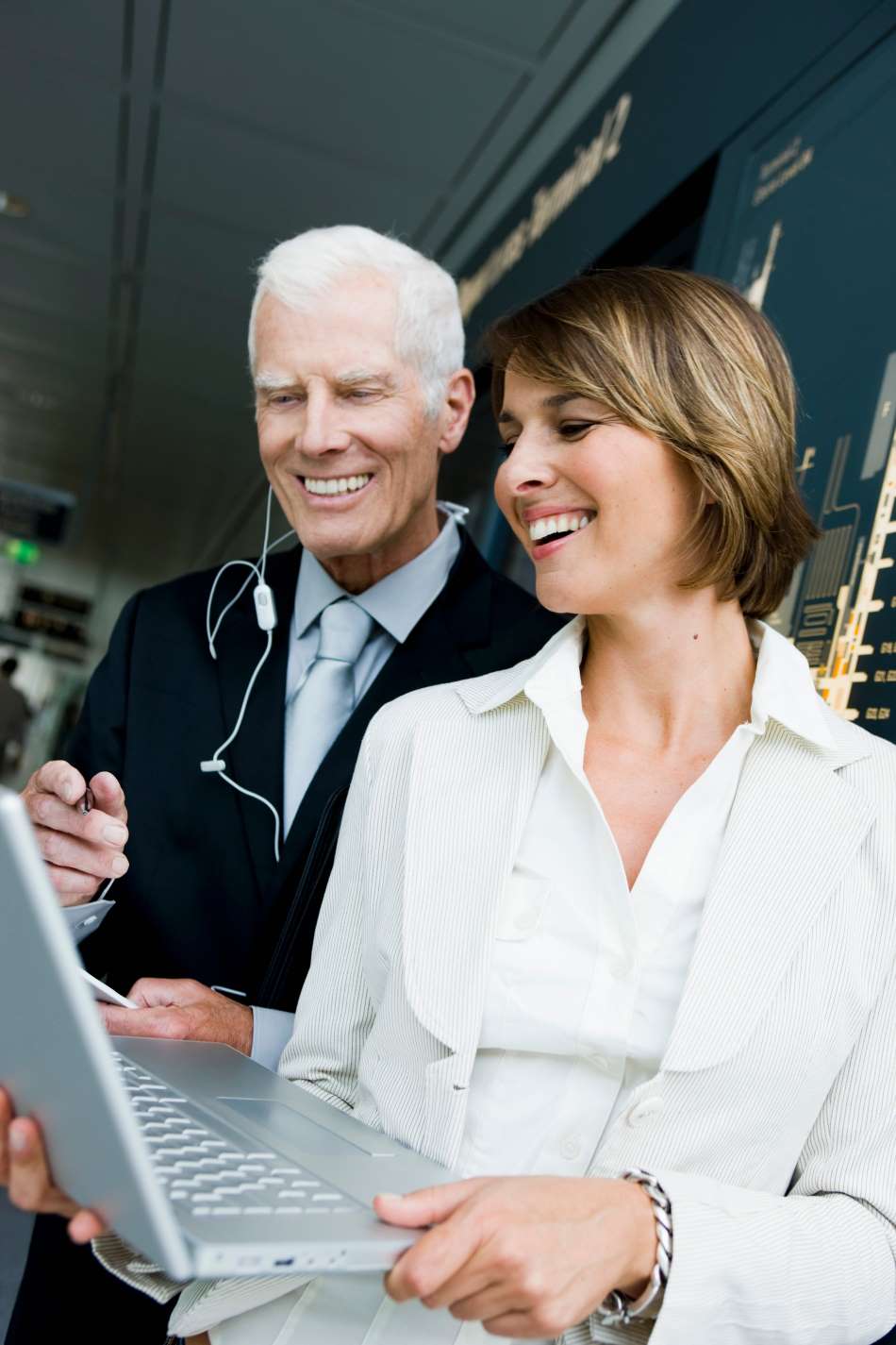 Older man and woman looking at laptop